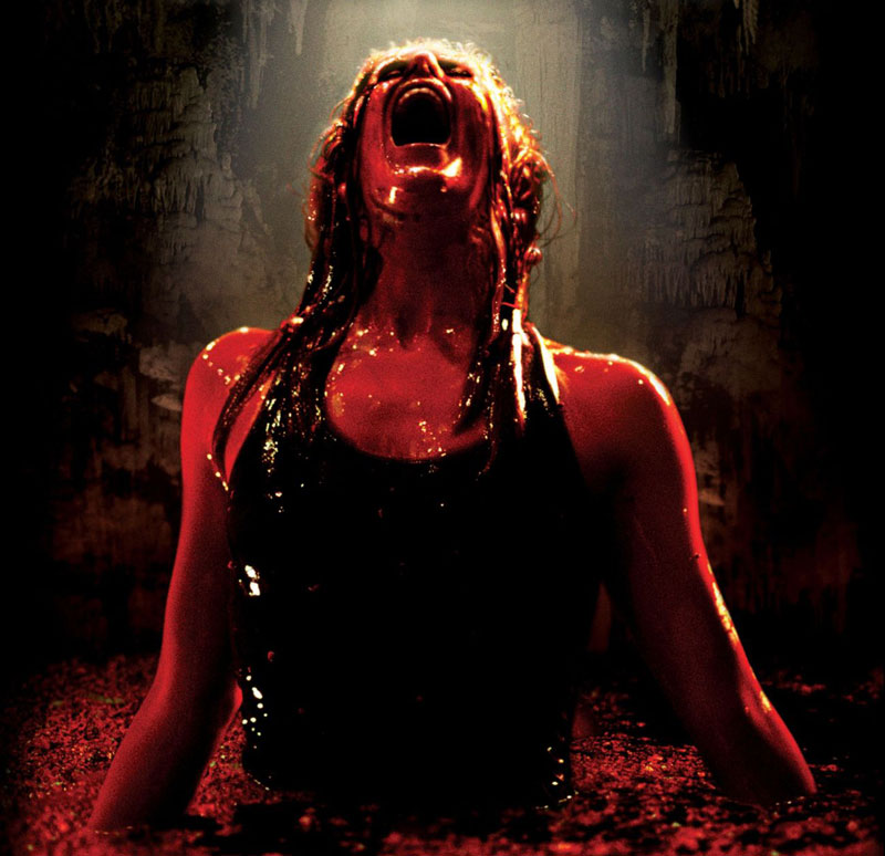 The lead actress from 'The Descent' standing and screaming while in a pool covered in blood