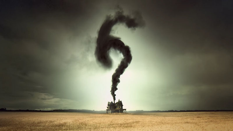 A house in a field with a cloud of smoke forming a 6 from 'American Horror Story' on FX