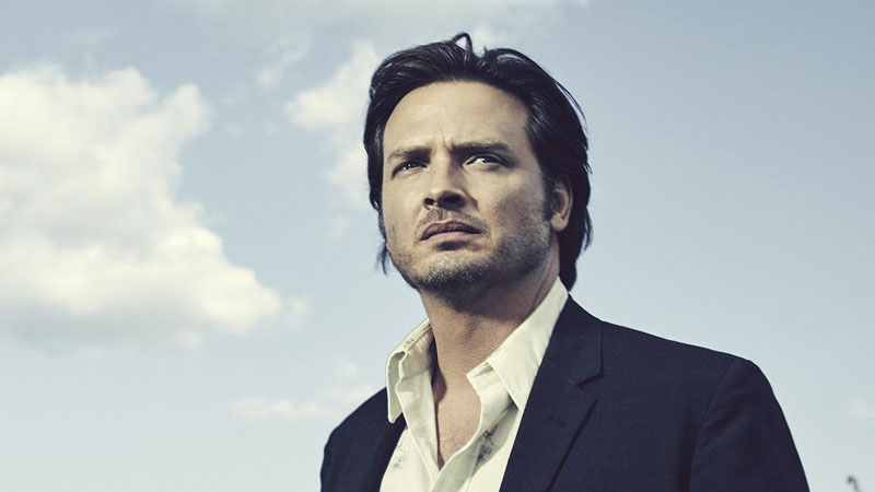 The lead actor from 'Rectify' on Sundance in a suit looking towards the viewer