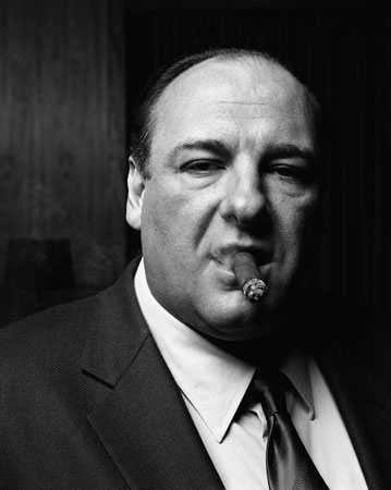 Actor 'James Gandolfini' from 'The Sopranos' on HBO looking at the viewer smoking a cigar